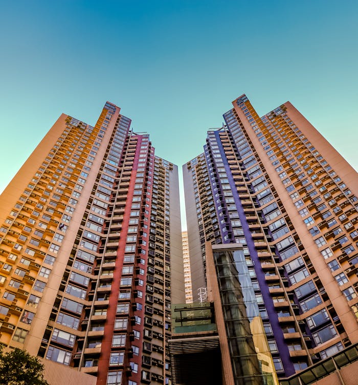 pexels-photo-1481105-1 Tall, colorful skyscrapers reaching into the blue sky in Hong Kong, showcasing modern architecture.